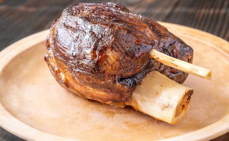 Glazed cooked pork hock on the plate