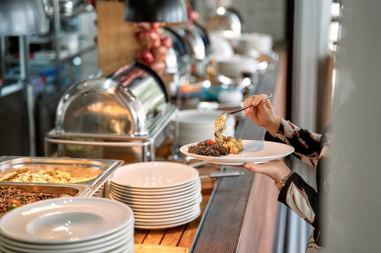 A person selects from a buffet at a restaurant