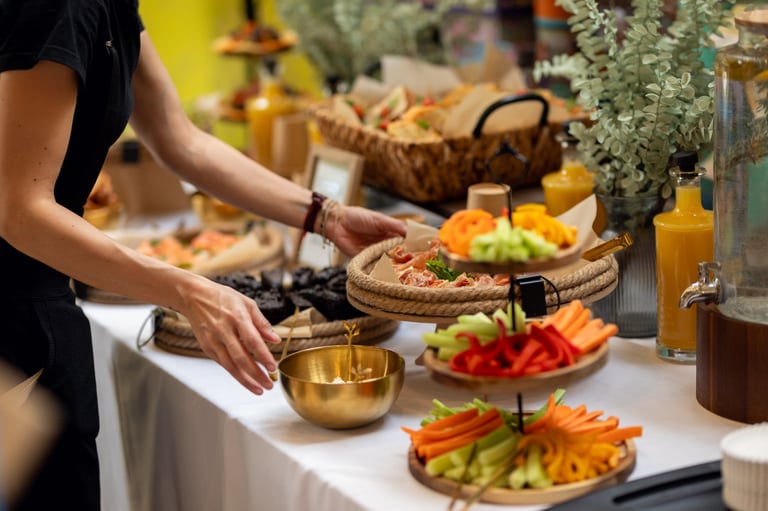 Professional caterer arranging buffet with colorful sandwiches
